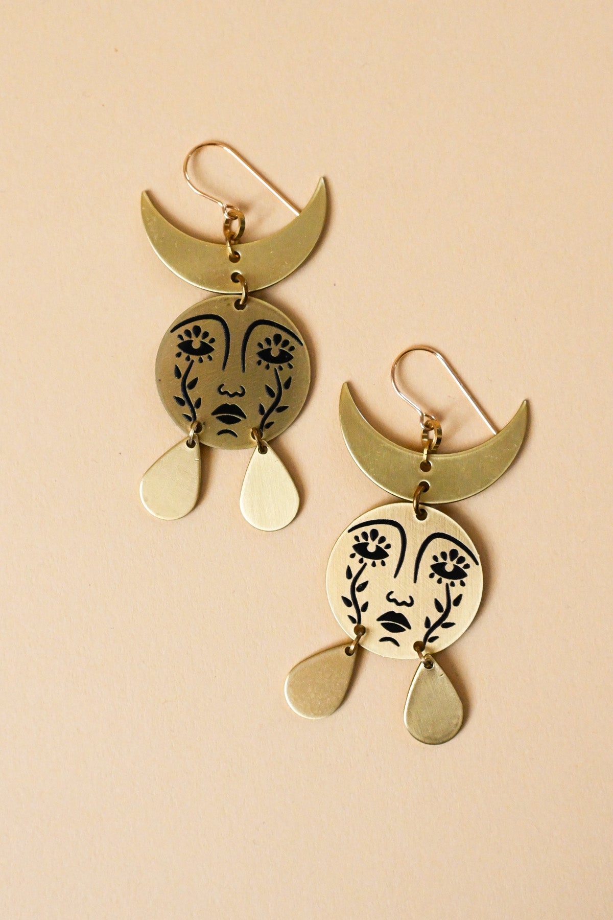 Gold face store earrings